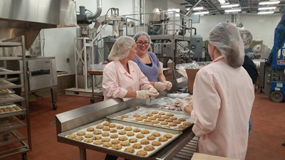 People bake cookies in the commercial food production facilities at UNL