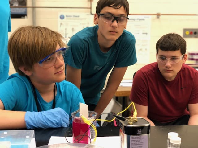 students watching an electrochemistry experiment