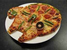A pizza in the shape of the Millennium Falcon