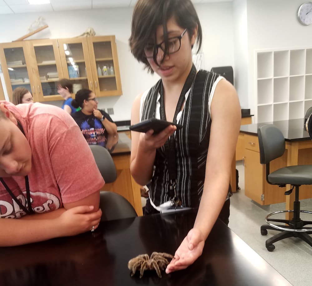 student with a tarantula