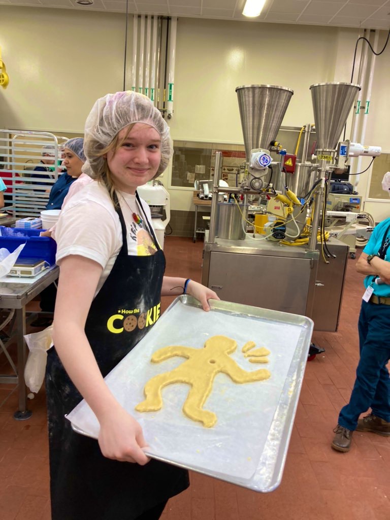 A camp participant shows her work during the cookie challenge, a competition to determine the best cookie designer.